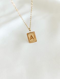 Experience the luxury of our 18k gold-plated stainless steel Initial Necklace! Free of lead and nickel, with a 16-inch chain and a 4-inch extender, you'll be stylishly adorned for any occasion. Vintage Initial Necklace, Elegant Gold-tone Nickel-free Necklaces, Trendy Pendant Charm Necklaces As Gift For Her, Trendy Pendant Charm Necklaces For Her, Trendy Pendant Charm Necklace Gift For Her, Trendy Pendant Charm Necklace For Her, Trendy Metal Rectangular Pendant Jewelry, Trendy Metal Jewelry With Square Pendant, Trendy Gold Plated Nickel-free Jewelry