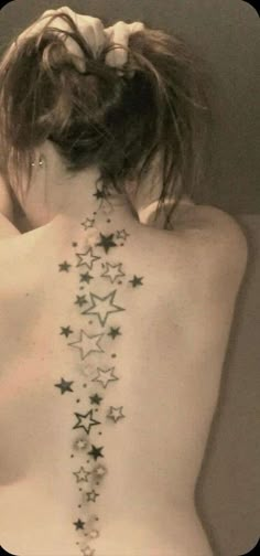 the back of a woman's body with stars on her upper and lower back