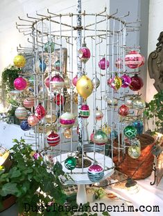 there are many ornaments hanging from the ceiling and on display in front of a window