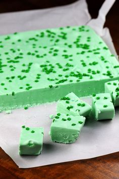 there are pieces of green cake on the table