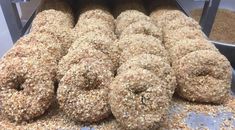 a bunch of doughnuts that are sitting on a shelf in a store or bakery