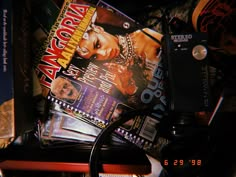 a pile of magazines and other items sitting on top of a table