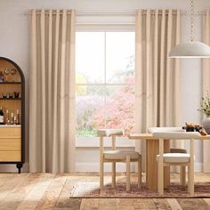 a dining table and chairs in front of a window with beige drapes on the windowsill