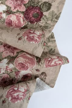 two pieces of fabric with pink and red flowers on them, sitting next to each other