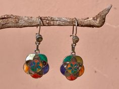 This beautiful Earring is handmade by the beautiful Quechua people of the Peruvian Andes.  It is handmade in 950 silver with inlaid stone and shell by a local family of jewelry artesians. weight :10.7 gr diameter : 2 cm height with hook : 4.8 cm Artisan Multicolor Earrings With Natural Stones, Multicolor Artisan Earrings With Natural Stones, Traditional Multicolor Sterling Silver Earrings, Traditional Pierced Flower Jewelry, Handmade Bohemian Earrings In Mother Of Pearl, Bohemian Handmade Mother Of Pearl Earrings, Traditional Silver Multi-stone Earrings, Artisan Flower Earrings, Traditional Sterling Silver Earrings With Natural Stones