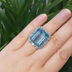 For Sale on 1stDibs - Ring set with 24 diamonds and one significant Aquamarine. Aquamarine Size: 1.75cm x 2.00 cm. Weight: 24.47 grammes. Ring Size: 55 / 7 US. Luxury Cluster Diamond Ring With Gemstone, Luxury Diamond Cluster Ring With Gemstones, Fine Jewelry Diamond Cluster Gemstones, Gia Certified Diamond Gemstones For Anniversary, Cluster Diamond Gemstones For Wedding, Diamond Baguette Cut Gemstone Rings, Dazzling Topaz Ring With Diamond And Prong Setting, Dazzling Emerald Cut Diamond Topaz Ring, Dazzling Diamond Ring