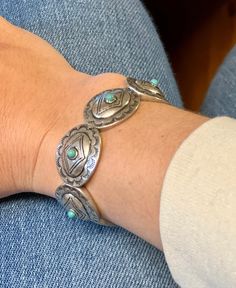 This western bracelet is concho style with little turquoise stones on the cocho for the perfect flair. It is a stretch style so it makes putting it on and off easy. Bracelet is 4" Zinc, brass, rhodium plated, stones lead compliant, nickel free to prevent tarnish. For best results, please avoid wet surfaces. This item is in stock and ready to ship same or next day from our warehouse in Rozet, Wyoming. Nickel Free Adjustable Southwestern Cuff Bracelet, Adjustable Turquoise Stamped Bracelets, Western Turquoise Bracelets With Concho, Western Turquoise Bracelet With Concho, Western Style Turquoise Bracelet With Concho, Adjustable Stamped Turquoise Bracelets, Adjustable Turquoise Western Bracelet, Adjustable Turquoise Cuff Bracelet With Concho, Southwestern Adjustable Nickel Free Bracelets