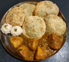 a metal plate topped with different types of food on top of a black countertop