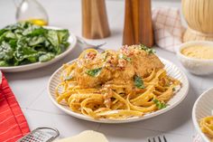 a table topped with plates of food and pasta