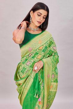 Elegant green georgette Banarasi saree is a perfect choice for festive occasions! It is enhanced with zari minakari jaal and comes with a matching blouse piece. Disclaimer: The shown stitched blouse on the model is for display purpose only. The saree comes with a matching blouse piece and finished with fall and piko. Green Pre-draped Saree With Meenakari For Puja, Festive Green Pre-draped Saree With Self Design, Green Georgette Pre-draped Saree For Transitional Season, Festive Green Pre-draped Saree With Zari Weaving, Green Bollywood Pre-draped Saree With Meenakari, Green Semi-stitched Pre-draped Saree With Meenakari, Festive Green Pre-draped Saree With Pallu, Festive Green Paithani Silk Pre-draped Saree, Green Cutdana Traditional Wear For Festive Season