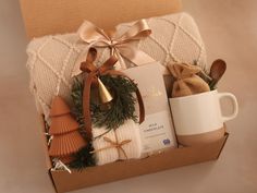 a gift box with coffee, cookies and other holiday items in it on a table