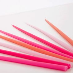 On a white background is a pack of different colored tapered candles in various shades of pink. Hot Pink Taper Candles, Tall Birthday Candles, Pink Taper Candles, Pink Party Theme, Tapered Candles, Orange Candle, Orange Party, Orange Table, Bachelorette Decorations