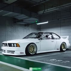 a white car parked in a parking garage