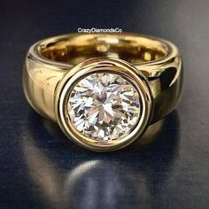 a yellow gold ring with a diamond in the center