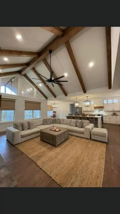 a living room filled with furniture and a ceiling fan in the middle of the room