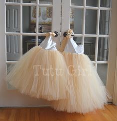 "Classic and beautiful, our one strap style tutu dress is made in a mix of ivory and our champagne/beige skirt. The top of the dress is FULLY LINED and the top of the strap opens to tie with a matching ribbon strap which ties at the right shoulder. The back of the dress is stretchy elastic along the top hem. We can make this dress in literally any color skirt (or even a mixture of colors). Convo us for questions. WANT A SEWN IN SLIP TO LINE THE TUTU? https://www.etsy.com/listing/125566641/add-a- Princess Style Cream Dress With Tulle Skirt, Cream Tulle Tutu Dress For Bridesmaids, Elegant Cream Tutu Dress For Dress-up, Cream Tulle Tutu Bridesmaid Dress, Cream Tulle Bridesmaid Tutu Dress, Cream Tulle Dress For Dress-up, Cream Tulle Tutu Dress For Wedding, Elegant Fitted Cream Tutu Dress, White Ballet Style Party Dress