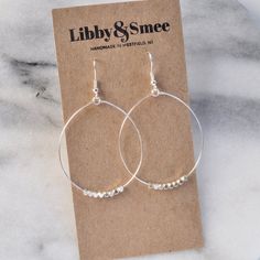 These big beaded hoops in gold or silver are the perfect simple statement — just right for those busy mornings when finding something that matches your outfit is just too much to ask. stainless steel ear wire and hand-shaped hoop with faceted beads choose gold-plated or silver-plated lead-free and nickle-free plastic earring back 2.5" long and 1.5" wide (each pair is handmade so sizes can vary slightly) packaged on a kraft earring card in a clear resealing bag Earrings Silver Hoops, Hoop Earrings Big, Homemade Earrings, Gifts For Girlfriends, Plastic Earrings, Earrings Big, Dangle Hoop Earrings, Mini Hoop Earrings, Chunky Beads