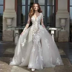 a woman in a wedding dress standing on a tile floor with her arms behind her back