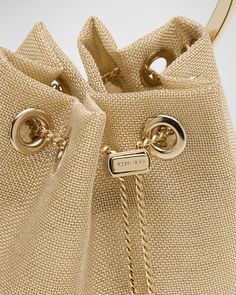 Jimmy Choo "Bon Bon" bucket bag in ProModal® rayon, polyester, and nylon    Metal top handle     Chain crossbody strap    Can be worn as a top handle or crossbody bag     Open top with drawstring closure     Approx. 5.9"H x 5.5"W x 3.7"D    Item Weight (Lbs.): 0.6    Made in Italy