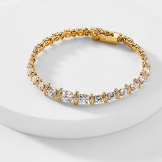 ABOUT THE PRODUCTA modern classic, this stunning tennis bracelet features an alluring mix of dazzling cubic zirconia stones, adding a touch of elegant glamour to any look. Metal: BrassPlating: 18KT Gold or RhodiumStones: Cubic ZirconiaLength: 7.25 in