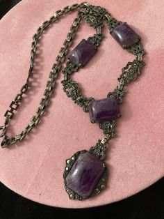 "COUPON CODE available at check out.  Antique 19th C Medieval Revival sterling amethyst stone pendant necklace. 13 marcasites dot this necklace. There are patterns within patters. Faux marcasite studs thru out. Picture frame style  filigree cut out sturdy flat solid sterling panels for bottom half of necklace.  An intricate flat square interlocking chain for the upper half. The square chain links are all intricately designed.  Back of center pendant is marked sterling.  Largest stone MEASURES:  Approx 3/4\" x 1/2\" (little more). Next 3 measure the same at approx: 1/2\" x 1/2\" (a little more.) Purple stone is freezing cold to the touch. Regular flashlight shown under light. See all photos. No cracks in any stones. Email any questions prior to purchase.  My opinion of the style might be di Victorian Style Necklace With Oxidized Finish, Victorian Style Necklace With Oxidized Finish For Gifts, Victorian Oxidized Finish Necklace For Gift, Victorian Antique Silver Pendant Necklace, Antique Silver Gemstone Necklace, Ornate Amethyst Necklaces For Formal Occasions, Ornate Purple Gemstone Necklaces, Ornate Purple Gemstone Necklace, Victorian Jewelry With Oxidized Finish, Collectible