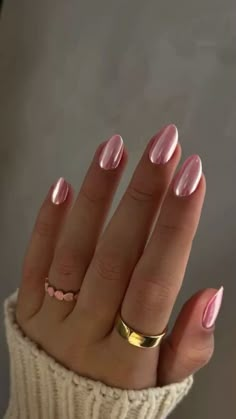 a woman's hand with pink manies and gold rings on it, while she is