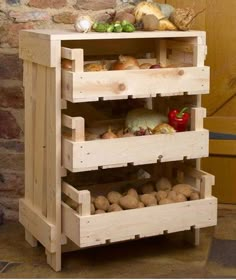 a wooden shelf with drawers filled with vegetables