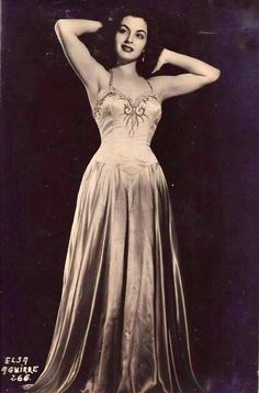 an old photo of a woman in a dress with spider on it's back