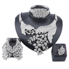 A metal platted stone upholstered jewelry set for party or wedding purposes. A shining jewelry set that attracts everyone's eye towards you enhances your beauty. the stone adds a shining effect to the jewelry. A piece is bound to get praised because of its beauty-enhancing quality. Features Material: Metal, Stone Style: Trendy Fine or Fashion: Fashion Item Type: Jewelry Sets Occasion: party Shape\pattern: Plant Jewelry Sets: gold plated What Includes 1 X Necklace set (1necklace, 1pair of earring Jewelry Sets Gold, Plant Jewelry, Costume Jewelry Sets, Crystal Statement Necklace, Crystal Jewelry Sets, Bangle Ring, Party Rings, Costume Party, Shape Patterns