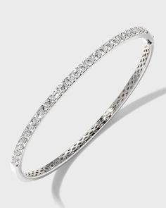 Diamond fashion bangle from Memoire..Polished 18-karat white gold hardware..26 round-cut, prong-set G-H/SI diamonds..Hinged opening with fold-over clasp..1.97 total diamond carat weight. Timeless Bangle With Pave Setting For Formal Occasions, Classic Hand Set Diamond White Bangle, Classic Diamond White Bangle Hand Set, White Gold Diamond Cut Bangle Bracelet, Classic Pave Setting Bangle For Formal Events, Classic Pave Setting Bangle For Formal Occasions, Luxury Brilliant Cut Bangle For Anniversary, Classic Bangle With Pave Setting For Anniversary, Classic Diamond Bangle For Anniversary