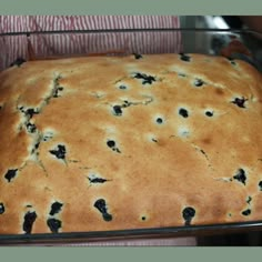 a loaf of blueberry bread sitting on top of a metal pan in the oven