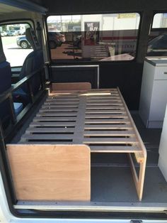 the bed in the back of a van is made to look like it has been built