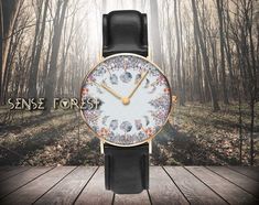 "Cottagecore cotton flower Moon phase witchy Watch, Gold color metal frame vegan leather band witch watch in gift box, Boho hippies gift * [Material]: Quartz, Black Vegan leather * [Dial Size]: 1.5 × 1.5\" * [Print Position]: Single-sided printing * [Color]: Gold(pointers) * [Package]: Premium gift box * [Care Instruction]: Do not wear while showering, bathing, or swimming ❣️PRODUCTION and DELIVERY TERMS: This item will be shipped out from China The production takes 5-7 business day International delivery time is 10-20 business days. 619 Watch Sense Forest would like to provide some clarity regarding the creation of our designs. We take pride in crafting all our designs in our dedicated workshop located in Las Vegas, USA. For some of our products, we handle the printing in-house. However, Mystical Moon Phase Jewelry, Bohemian Moon Phase Charm Necklaces As Gift, Bohemian Moon Phase Necklaces As Gift, Witchy Moon Phase Jewelry Gift, Moon Phase Watch Women, Witch Watch, Flower Moon, Cotton Flower, Floral Moon