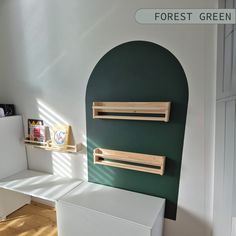 a room with white furniture and green walls