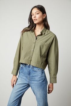 The model is wearing an oversized LUCILLE CROPPED BUTTON-UP SHIRT in olive green by Velvet by Graham & Spencer. Cropped Button Up Shirt, Blouse Size Chart, Velvet Tees, La Fashion, A Button, Clothes Horse, Short Shirts, Contemporary Fashion, Fashion Labels