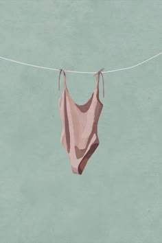 a piece of cloth hanging from a clothes line on a blue background with white string