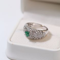 Featuring a heart-shaped emerald centerpiece surrounded by a dazzling halo of diamonds, this delicate ring embodies the essence of vintage elegance. The rich green color of emeralds symbolizes love and vitality, while sparkling diamonds add a touch of glamor. Metal: 18ct Recycled White Gold Plated On Recycled Sterling Silver Gemstone: Cubic Zirconia,Artificial Emerald Gemstone Ring Dimensions: High 10mm Ring Sizes Available: US 6, 7, 8, 9 Weight: 7g