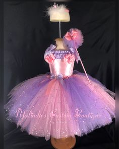 Pink and purple layered tutu dress with sparkling tulle tiara and wand. Smooth satin bodice with extra fluffy tulle to provide the ultimate fullness and fluff of a princess dress. Note : gems and jewels maybe changed based on availability. Colors will be pink , purple or clear to coordinate with the look of dress. Princess Style Festive Pageant Dress, Lavender Princess Dress For Wedding, Fairytale Princess Dress For Costume Party, Pink Princesscore Dress For Halloween, Lavender Princess Dress For Dress-up, Lavender Princess Dress For Pageant, Lavender Princess Dress For Pageants, Lavender Princess Dress For Dress-up Occasions, Fitted Princess Style Pageant Dress For Dress-up