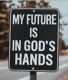 a black and white sign that says my future is in god's hands on it