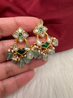 Jadau Kundan Dainty Earrings screwback earringsColor : GoldenSize : Length : 1.5 Inches; Weight : 8 grams eachStones : Green Jadau Kundan Pearls Green Beads Gold Teardrop Earrings With Stones, Kundan Jeweled Earrings As Gift, Kundan Jeweled Earrings For Gift, Dangle Earrings With Stones For Wedding, Dangle Stone Earrings For Wedding, Traditional Festival Earrings With Stones, Green Earrings For Anniversary And Festivals, Kundan Earrings With Stones For Wedding, Chandbali Jeweled Earrings For Gifts