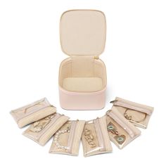 six pieces of jewelry in a case on a white background, with the contents laid out