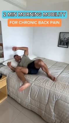 a man laying on top of a bed next to a dresser and tv set with the caption, 2 min morning mobility for chronic back pain