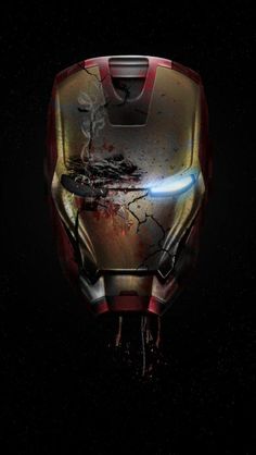 the iron man helmet is seen in this image, with red and yellow paint splattered on it