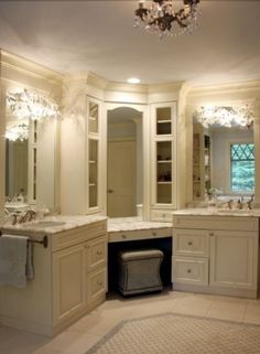 a large bathroom with double sinks and two mirrors