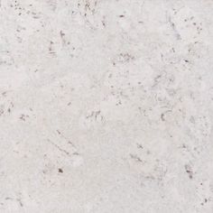 a white marble counter top with brown speckles