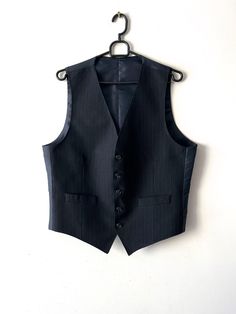 "Vintage Dark blue striped mens vest Gentleman's Vest Mens Formal Fitted Waistcoat Size Medium Mens Vest Navy Classic Vest Wedding Groom Vest Label size: B 52 Estimated size: M Measurements: (lying flat) Length - 22.5\"/ 57 cm Pit to pit: 21\"/ 53.5 cm Waist - 19\"/ 48.2 cm Please check measurements to insure a proper fit. Remember to allow yourself some extra room for movement. You can compare these with something from your closet that fits you well. This vest will come to you freshly laundered and ready to wear. Please feel free contact me if you need additional measurements or have any questions Condition: great vintage condition SHIPPING * I ship worldwide via Priority mail (Latvijas Pasts) from Latvia (EU). * I ship from Europe, so please allow 2 to 4 weeks for the package to arrive i Elegant Tailored Pinstripe Vest, Elegant Pinstripe Business Vest, Tailored Pinstripe Business Vest, Tailored Pinstripe Vest For Business, Tailored Pinstripe Sleeveless Vest, Pinstripe Tailored Sleeveless Vest, Tailored Sleeveless Pinstripe Vest, Elegant Pinstripe Vest For Formal Occasions, Classic Pinstripe Formal Vest