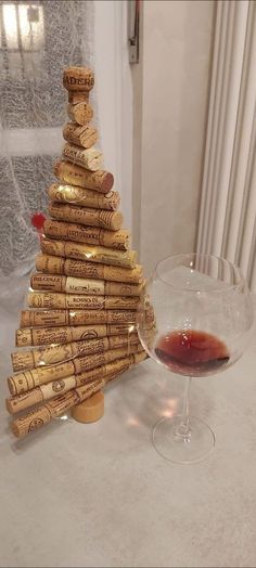 a wine glass sitting next to a cork christmas tree