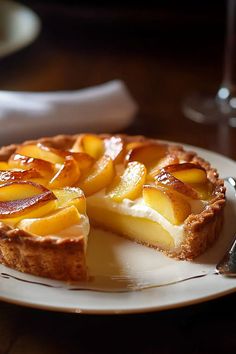 there is a pie with peaches on the plate