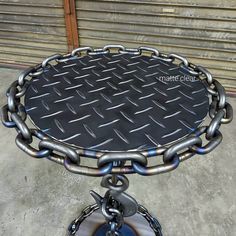 a metal table that has some chains on it