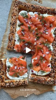 the salmon tart is topped with onions and dill on toasted rye bread